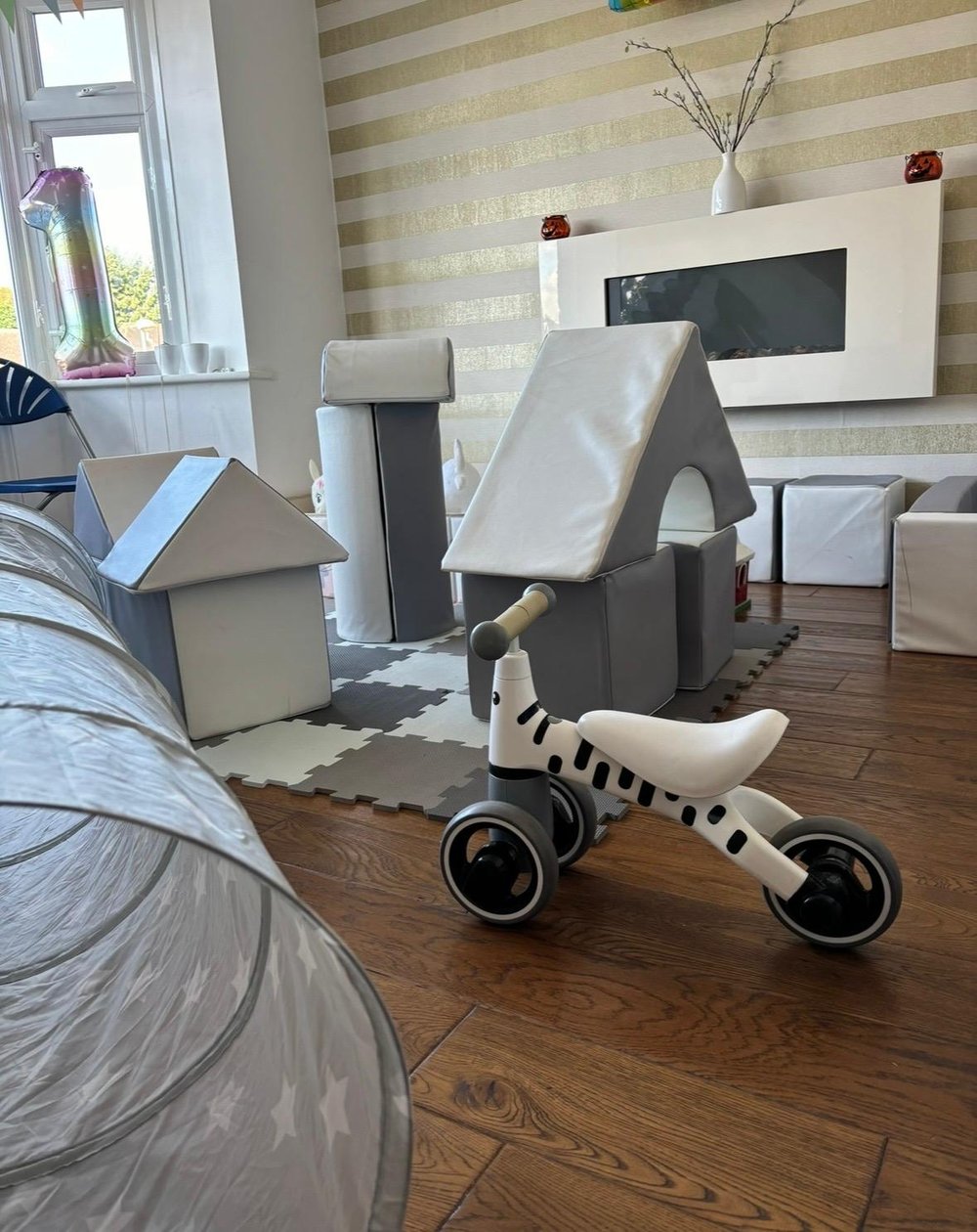 Grey and white soft play with house-shaped soft blocks, tunnel and ride-on zebra